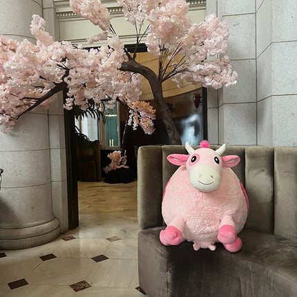 massive strawberry cow sitting on bench